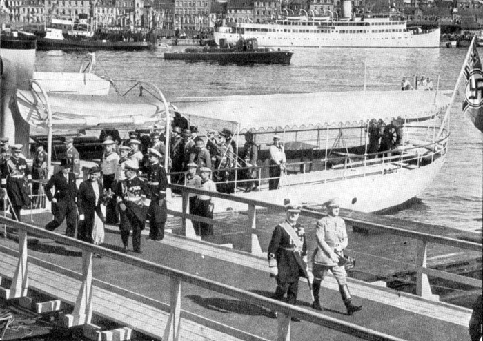 Adolf Hitler and Myklos Horthy, with Horthy's wife behind them, are leaving the Nixe yacht for the launch of the Prinz Eugen in Kiel